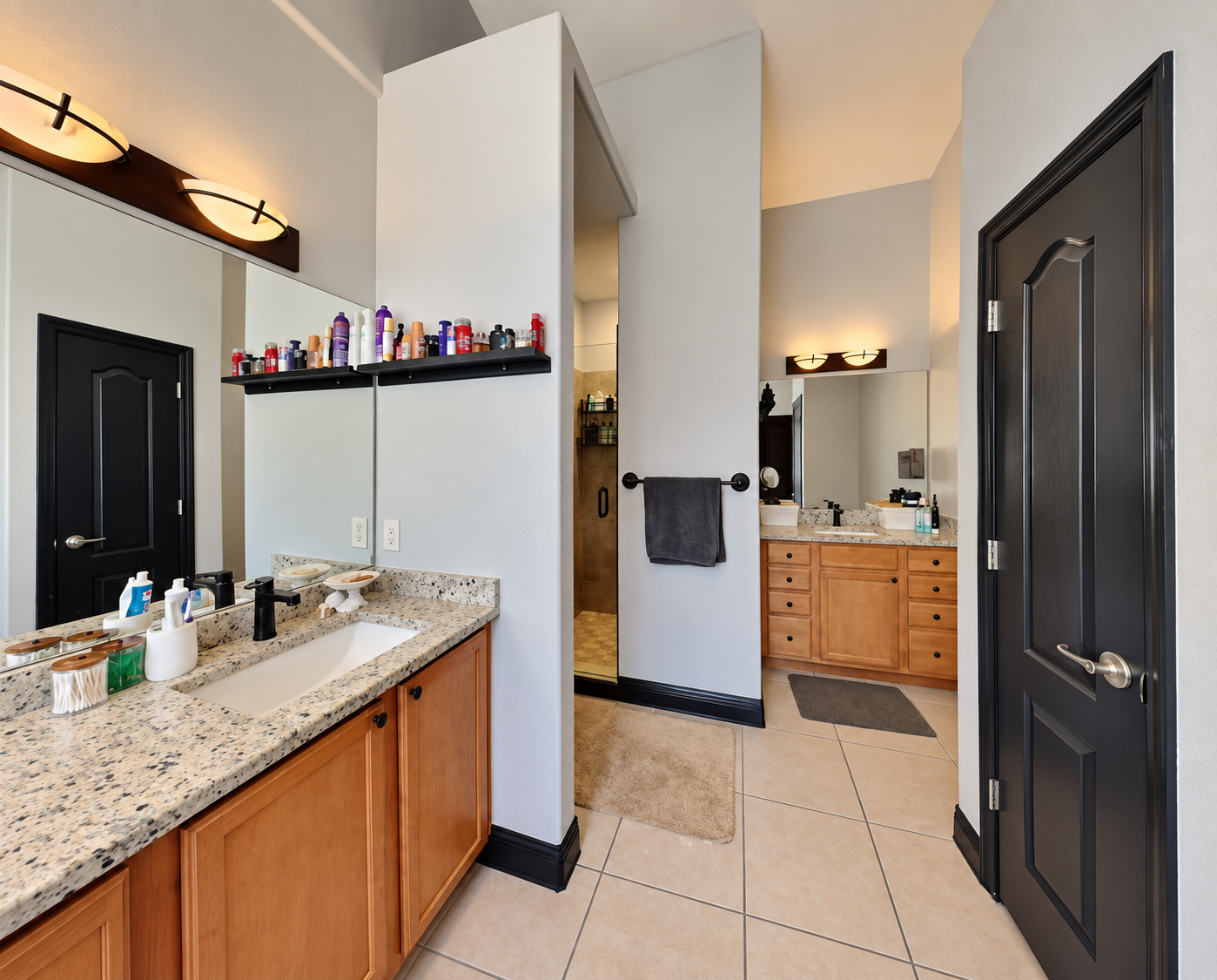 Dated bathroom with oak vanity, beige tile and granite counters before remodeling