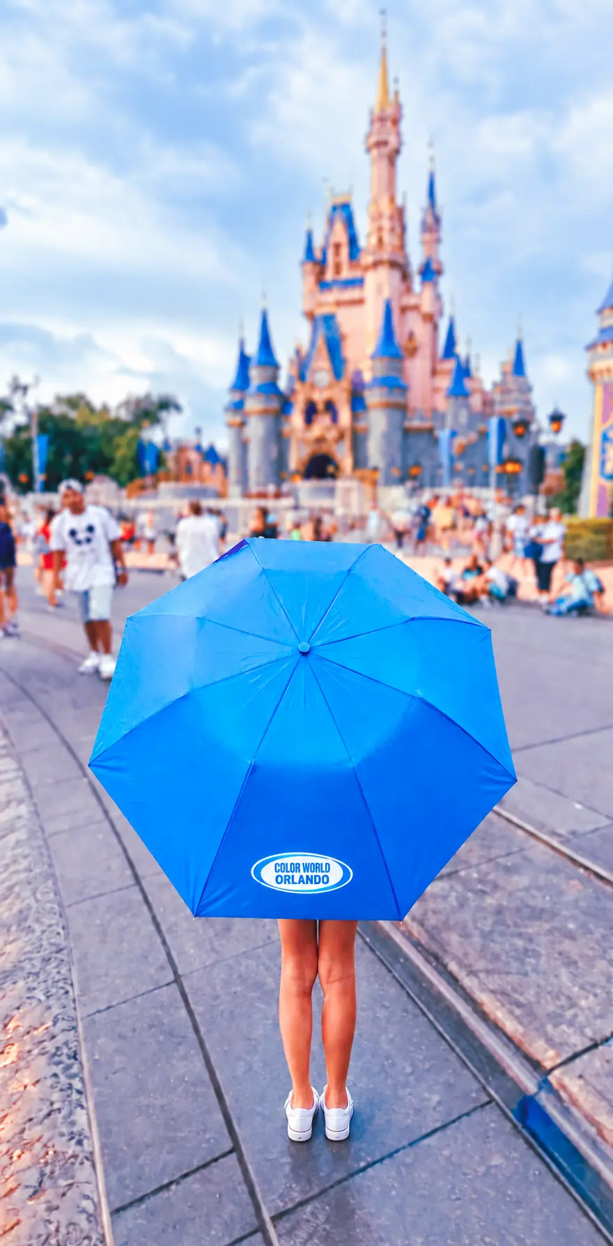 Color World Orlando branded umbrella in front of the Disney castle in Orlando