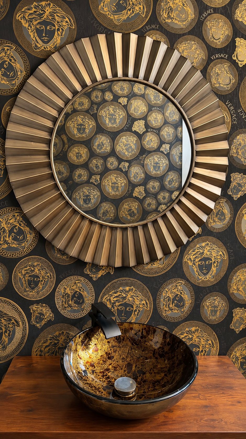 Powder room with bold black and gold patterned wallpaper, round sunburst mirror and glass vessel sink