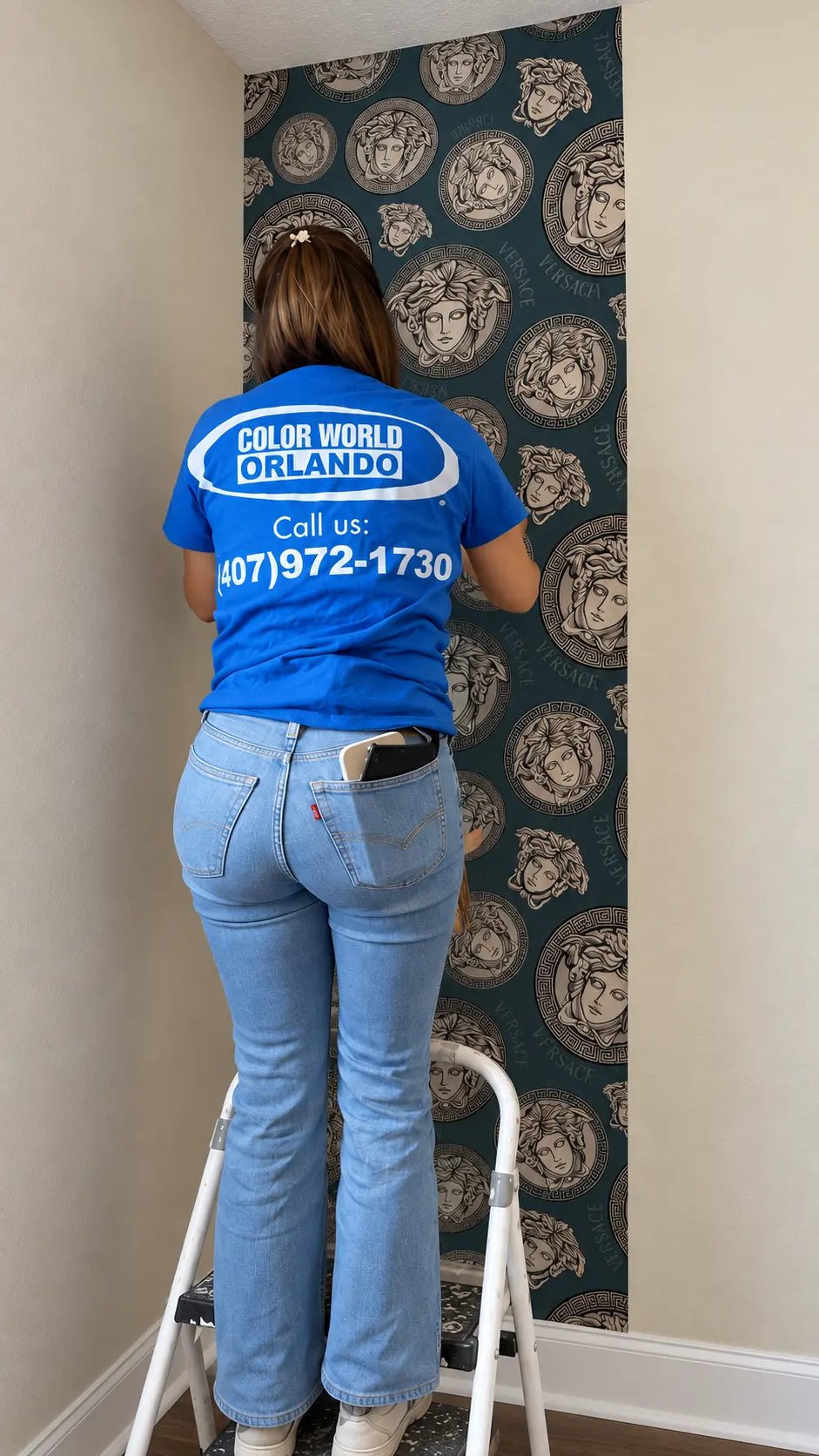 Color World Orlando team member installing patterned wallpaper on an accent wall